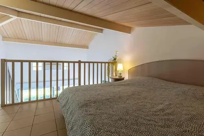 a bedroom with a bed and a view of the ocean at Bella Vista , à Porticcio, joli appartement vue mer in Grosseto-Prugna
