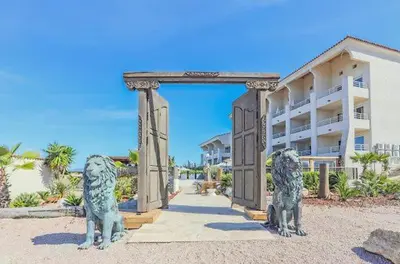 two statues of lions in front of a building at Bella Vista , à Porticcio, joli appartement vue mer in Grosseto-Prugna