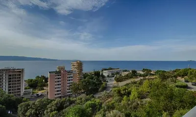 a view of a city with the ocean and buildings at AJACCiO VUE MER ET GOLFE in Ajaccio
