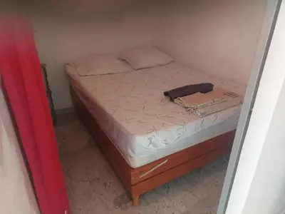 a bed in a small room with a phone on it at AJACCiO VUE MER ET GOLFE in Ajaccio