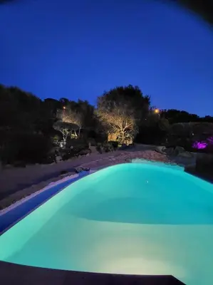 a large green swimming pool at night at Casa Marcelli 5 in Porto-Vecchio