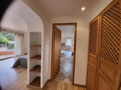 a room with a door and a bathroom with a toilet at Casa Marcelli 5 in Porto-Vecchio