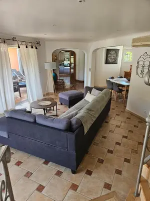 a living room with a blue couch and a table at Casa Marcelli 5 in Porto-Vecchio