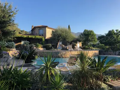 a villa with a swimming pool in a garden at Villa Valentine by Intendance Excellency in Porto-Vecchio