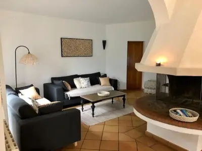 a living room with a couch and a fireplace at Villa Valentine by Intendance Excellency in Porto-Vecchio