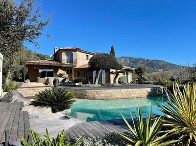 a house with a swimming pool in front of a house at Villa Valentine by Intendance Excellency in Porto-Vecchio