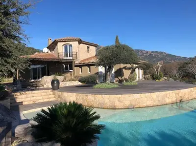 a house with a swimming pool in front of a house at Villa Valentine by Intendance Excellency in Porto-Vecchio
