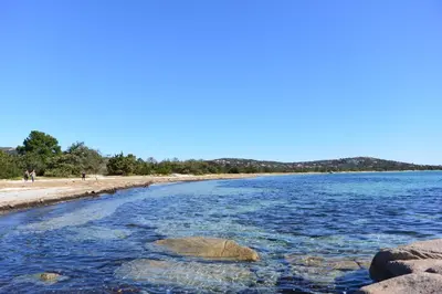 a view of a beach with rocks in the water at ST CYPRIEN C18 -4/6 pers- CLIM- à 250m de la plage de sable Saint Cyprien in Lecci