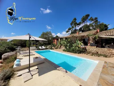 a swimming pool in front of a house at Casa Salya 8 pers Piscine privée Chauffée San Cipriano in Lecci