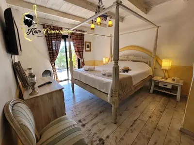 a bedroom with a canopy bed in a room at Casa Salya 8 pers Piscine privée Chauffée San Cipriano in Lecci