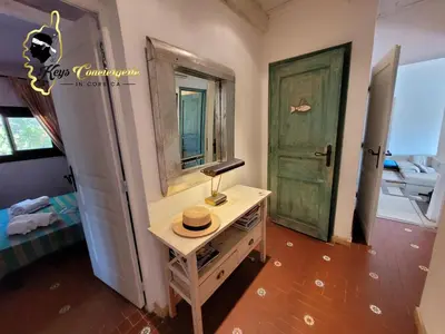 a room with a table with a hat on it at Casa Salya 8 pers Piscine privée Chauffée San Cipriano in Lecci