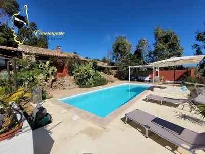 a swimming pool with two lounge chairs and a house at Casa Salya 8 pers Piscine privée Chauffée San Cipriano in Lecci