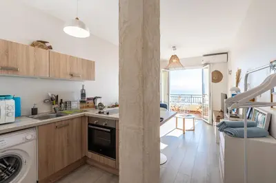a kitchen with a sink and a dishwasher at A Piaghja, refuge romantique face à la mer in Ajaccio