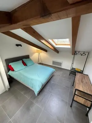a bedroom with a bed and a wooden table at Villa Colombo in Bonifacio