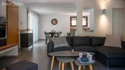 a living room with a couch and a table at Villa Colombo in Bonifacio