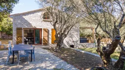 a brick house with a table in front of it at Villa Colombo in Bonifacio