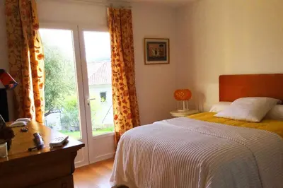 a bedroom with a bed and a large window at Villa Roccu in Borgo