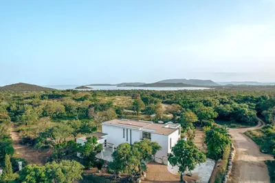 an aerial view of a white building with a road at Villa Bambou 12 pers piscine chauffée 10 minutes à pieds plage in Sainte-Lucie de Porto-Vecchio