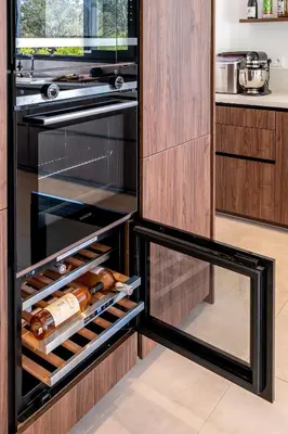 a kitchen with an open refrigerator with wine racks at Villa Bambou 12 pers piscine chauffée 10 minutes à pieds plage in Sainte-Lucie de Porto-Vecchio
