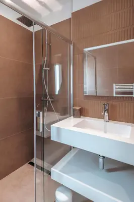 a bathroom with a sink and a shower at Villa Bambou 12 pers piscine chauffée 10 minutes à pieds plage in Sainte-Lucie de Porto-Vecchio