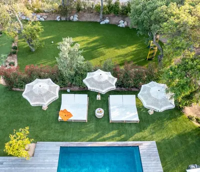 an aerial view of a lawn with umbrellas and a pool at Villa Bambou 12 pers piscine chauffée 10 minutes à pieds plage in Sainte-Lucie de Porto-Vecchio