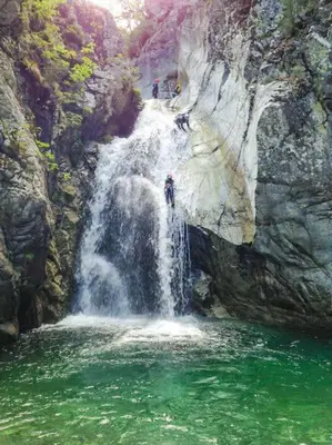 a group of people standing in front of a waterfall at Studio Venaco Centre Corse in Venaco