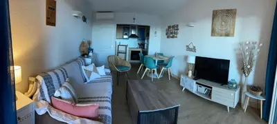 a living room with a couch and a tv at F2 vue mer dans résidence avec piscine in Ajaccio