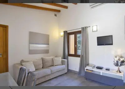 a living room with a couch and a table at Maison en pierre corse avec vue entre mer et montagne in Moltifao