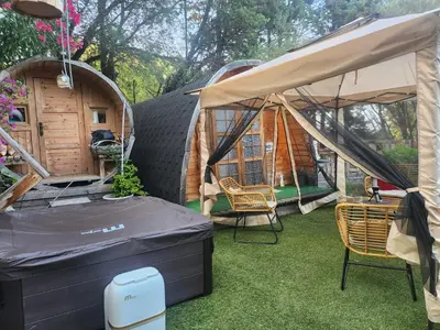 a gazebo with two chairs and a table at Cabana Exotique Piscine et Jacuzzi in Porto-Vecchio