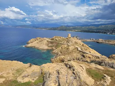 a view of a rocky island in the water at Charmant petit logement à 3 kms de la plage in Belgodère