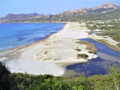 an island in the middle of a body of water at Charmant petit logement à 3 kms de la plage in Belgodère