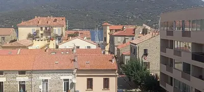 a group of buildings with red roofs in a city at Appartement lumineux et central in Propriano