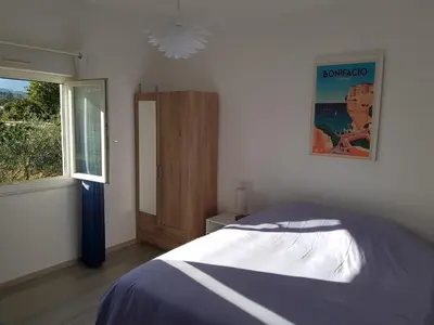 a bedroom with a bed and a window at GIORGHA VILLA Piscine chauffée 15 pers avec piscine vue mer montagne 1km mer in Solaro