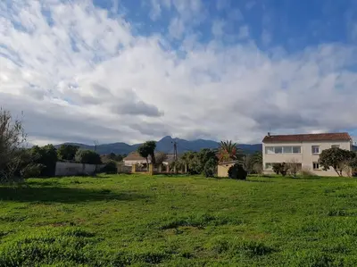 a green field with a house in the background at GIORGHA VILLA Piscine chauffée 15 pers avec piscine vue mer montagne 1km mer in Solaro