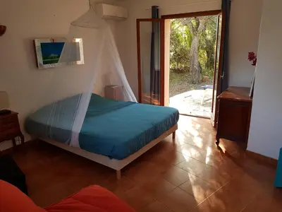 a bedroom with a bed with a canopy at LA MARINE Piscine chauffée villa avec piscine 5 mn à pied de la mer in Solaro