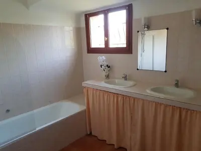a bathroom with two sinks and a tub and a mirror at LA MARINE Piscine chauffée villa avec piscine 5 mn à pied de la mer in Solaro