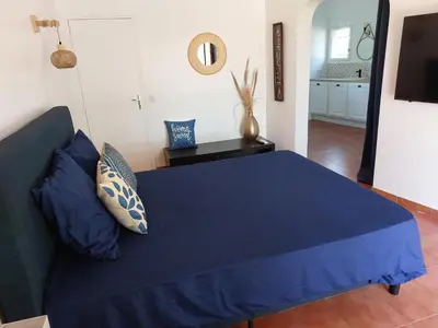 a blue bed with blue pillows in a room at LA MARINE Piscine chauffée villa avec piscine 5 mn à pied de la mer in Solaro