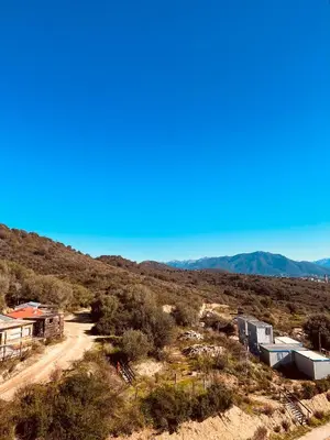 a dirt road in the middle of a hill with houses at SUPERBE STUDIO AVEC PLACE DE PARKING in Ajaccio