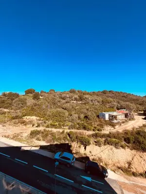 a truck parked on a road next to a mountain at SUPERBE STUDIO AVEC PLACE DE PARKING in Ajaccio
