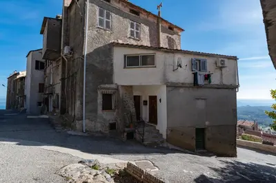 an old building on the side of a street at Pentone in Cervione