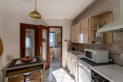 a kitchen with a sink and a microwave at Pentone in Cervione