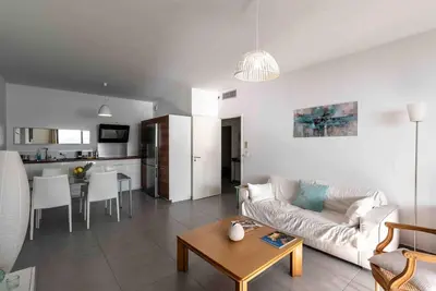 a living room with a couch and a table at Ajaccio, les Cyclades, magnifique appartement vue mer in Ajaccio