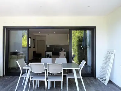 a dining room with a table and chairs at Apartment Les Jardins d'Ève-F2 by Interhome in Favone