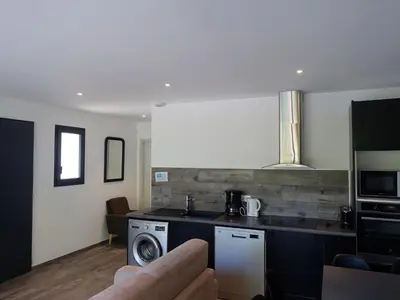 a kitchen with a washer and dryer in a room at Apartment Les Jardins d'Ève-F2 by Interhome in Favone