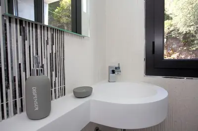 a white bathroom with a vase on a counter at Le SAN PETRONE-TOUR EN PIERRE EN CENTRE CORSE ENTRE MER ET MONTAGNE in Moltifao