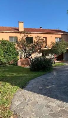 a house with a driveway in front of a building at Casa Rossa Solenzara in Sari Solenzara