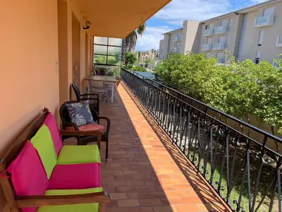 a balcony with two chairs and a railing at Casa Rossa Solenzara in Sari Solenzara