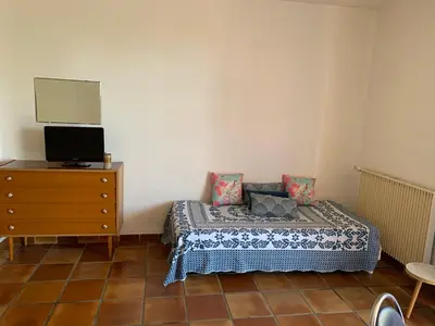 a bedroom with a bed and a dresser with a mirror at Casa Rossa Solenzara in Sari Solenzara