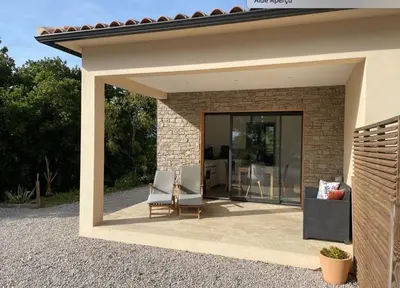 a patio of a house with two chairs at T1 traversant, plain pied entre mer et montagne in Cuttoli-Corticchiato