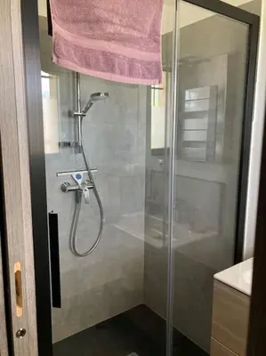 a bathroom with a shower with a glass door at T1 traversant, plain pied entre mer et montagne in Cuttoli-Corticchiato